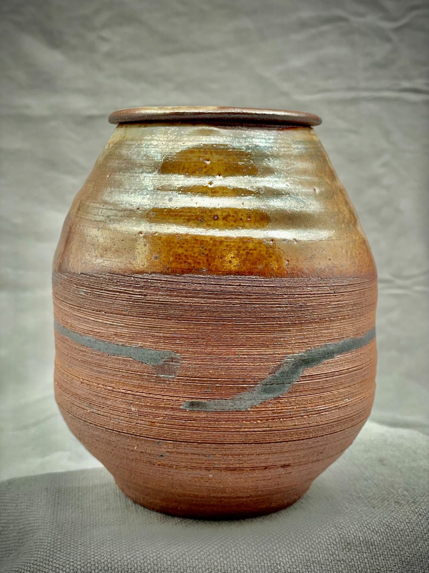 Wood fired lidded jar. Shino glaze, local iron-rich decoration